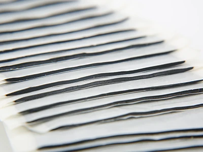 Multiple butyl semi-solid vibration damping blocks of the same size placed on a table