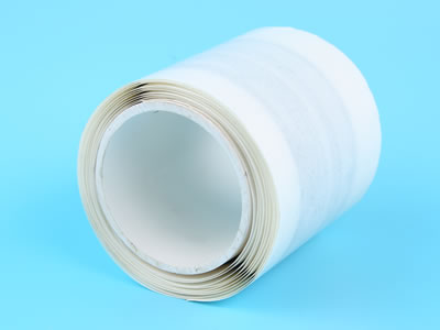 One roll of side placement butyl sealant tape is lying on the blue background.