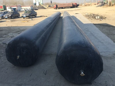 2 round rubber inflated culvert balloons placed on the ground