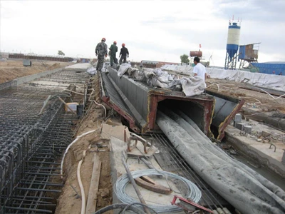 An uninflated rubber inflated culvert balloon placed inside the hollow core precast beam