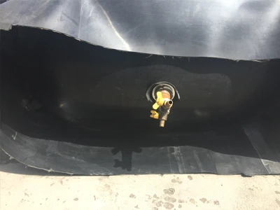 A deflated rubber inflated culvert balloon with an air valve on one end