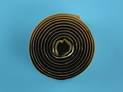 A roll of single sided butyl tape is put on the blue background from overlook view.