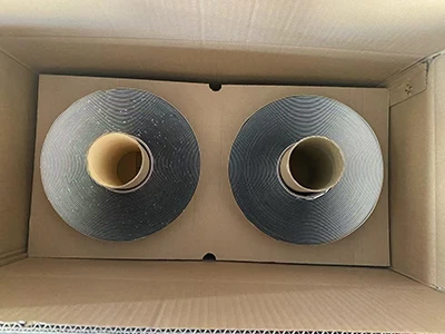 Two black sealants of double-sided butyl tape placed side by side in a carton