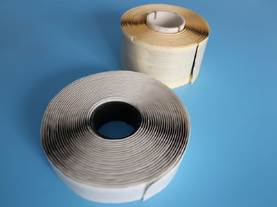 There are two different kinds of single sided butyl tapes lying on the blue background, and the fine size is in front of the wide size.